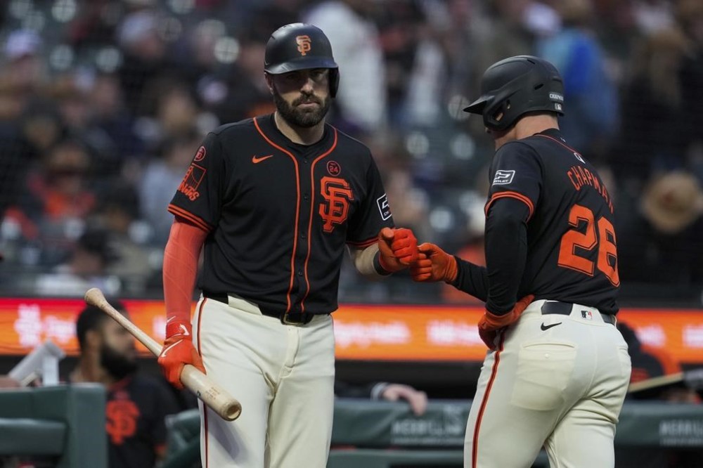 San Francisco Giants' Matt Chapman, right, celebrates with Curt Casali after scoring against the Colorado Rockies on Brett Wisely's double during the second inning of the second game of a baseball doubleheader Saturday, July 27, 2024, in San Francisco. (AP Photo/Godofredo A. Vásquez)