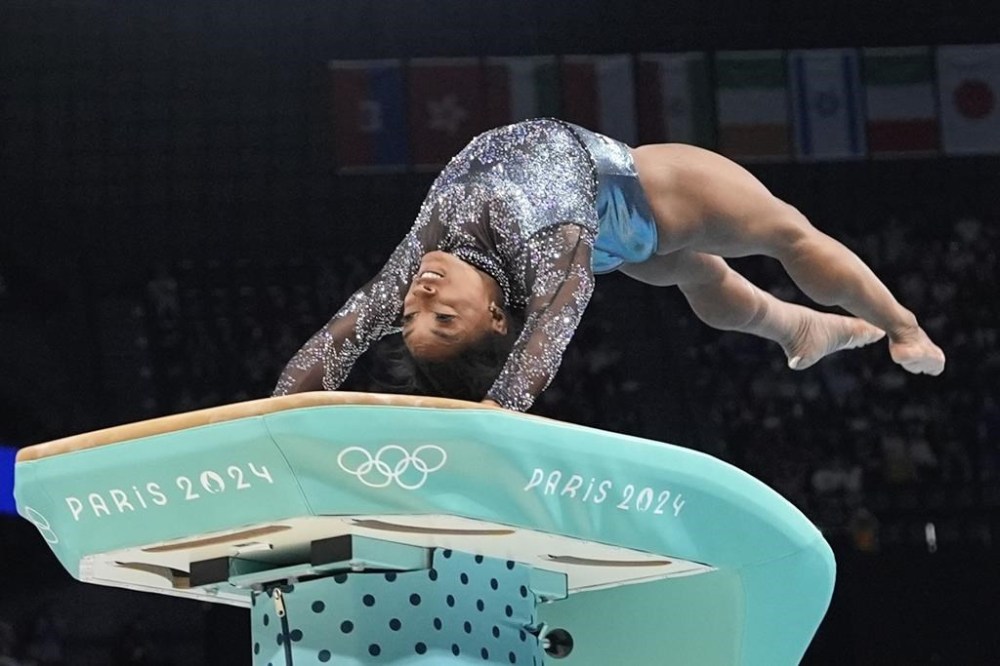 Simone Biles, of United States, competes on the vault during a women's artistic gymnastics qualification round at Bercy Arena at the 2024 Summer Olympics, Sunday, July 28, 2024, in Paris, France. (AP Photo/Charlie Riedel)