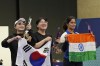 Silver medalist South Korea's Kim Yeji, left, gold medalist South Korea's Oh Ye-Jin, center, and bronze medalist India's Manu Bhaker celebrate after the 10m air pistol women's final round at the 2024 Summer Olympics, Sunday, July 28, 2024, in Chateauroux, France. (AP Photo/Manish Swarup)