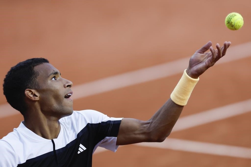 Canada's Felix Auger-Aliassime serves against Ben Shelton of the U.S. during their third round match of the French Open tennis tournament at the Roland Garros stadium in Paris, Friday, May 31, 2024. Auger-Aliassime and Bianca Andreescu started off Sunday’s matches at the Paris Olympics with straight-set victories. THE CANADIAN PRESS/AP/Jean-Francois Badias