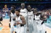 Members of the South Sudan team pose after they defeated Puerto Rico in a men's basketball game at the 2024 Summer Olympics, Sunday, July 28, 2024, in Villeneuve-d'Ascq, France. (AP Photo/Michael Conroy)