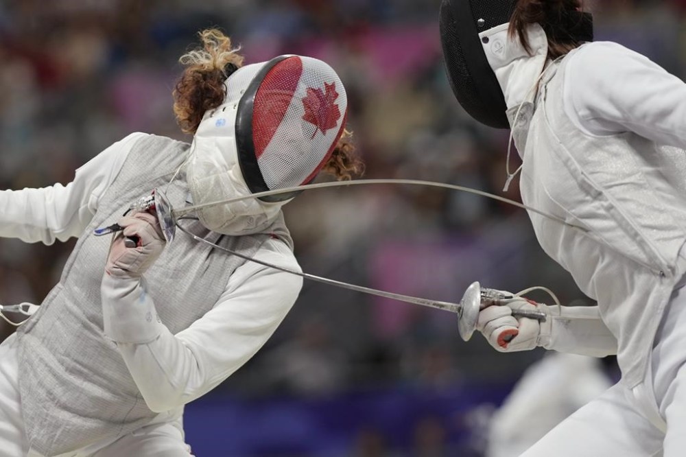 Canada's Eleanor Harvey, left, and China's Yuting Wang compete in the women's individual Foil round of 32 competition during the 2024 Summer Olympics at the Grand Palais, Sunday, July 28, 2024, in Paris, France. THE CANADIAN PRESS/AP/Andrew Medichini