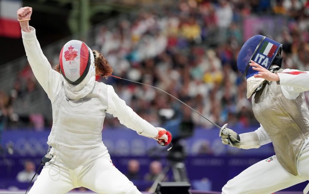 Eleanor Harvey, of Canada, celebrates her win over Martina Favaretto, of Italy, in the women's individual foil in Paris, France on Sunday, July 28, 2024. THE CANADIAN PRESS/Christinne Muschi