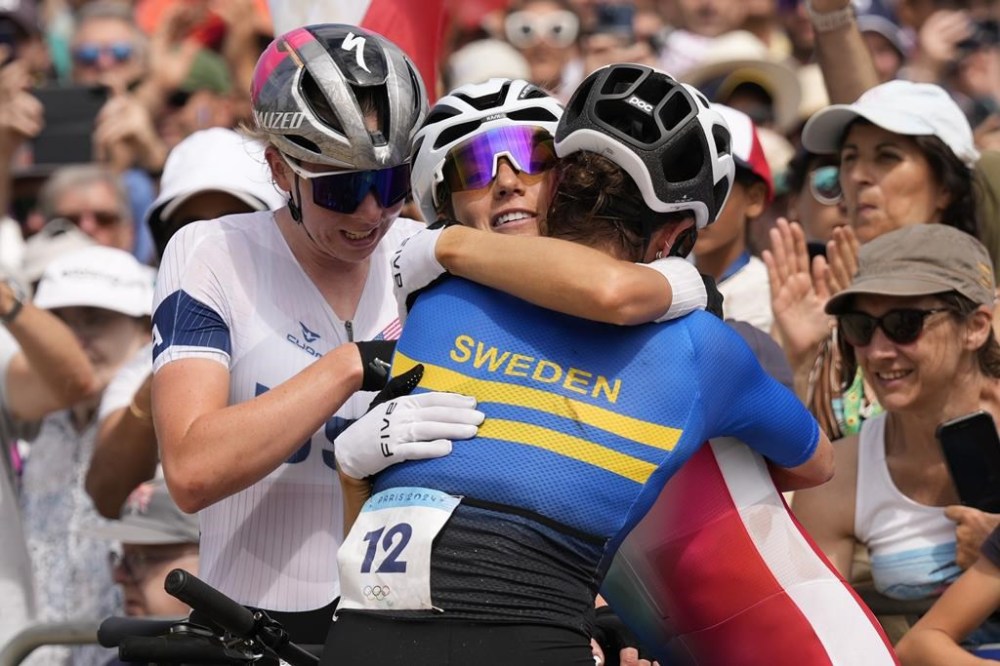From left, Haley Batten, of United States, silver, Pauline Ferrand Prevot, of France, gold, and Jenny Rissveds, of Sweden, bronze, after completing the women's mountain bike cycling event, at the 2024 Summer Olympics, Sunday, July 28, 2024, in Elancourt, France.