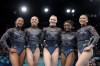 Team USA from left to right, Jordan Chiles, Hezly Rivera, Jade Carey, Simone Biles and Sunisa Lee, right, pose for photos after competing in a women's artistic gymnastics qualification round at Bercy Arena at the 2024 Summer Olympics, Sunday, July 28, 2024, in Paris, France. (AP Photo/Charlie Riedel)