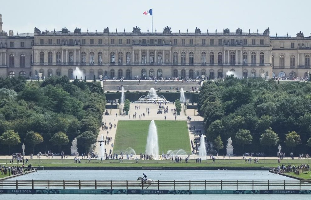 A rider crosses a bridge during the Equestrian Cross Country competition at Chateau de Versailles for the 2024 Summer Olympics, Sunday, July 28, 2024, in Versailles, France. (AP Photo/Mosa'ab Elshamy)