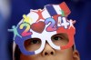 A spectator watches the opening ceremony for the 2024 Summer Olympics in Paris, France, Friday, July 26, 2024. (Steph Chambers/Pool Photo via AP)
