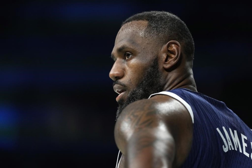 LeBron James, of the United States, stands on the court during a men's basketball game against Serbia at the 2024 Summer Olympics, Sunday, July 28, 2024, in Villeneuve-d'Ascq, France. (AP Photo/Michael Conroy)