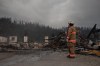 Fire crews work to put out hot spots in the Maligne Lodge in Jasper, Alta., on Friday July 26, 2024. As residents of Jasper learn more details about wildfire damage to their evacuated town, the Alberta and federal governments say they'll match donations to the Canadian Red Cross for wildfire relief in the province. THE CANADIAN PRESS/Amber Bracken