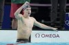 Leon Marchand, of France, celebrates after winning the men's 400-meter individual medley final at the 2024 Summer Olympics, Sunday, July 28, 2024, in Nanterre, France. (AP Photo/Matthias Schrader)