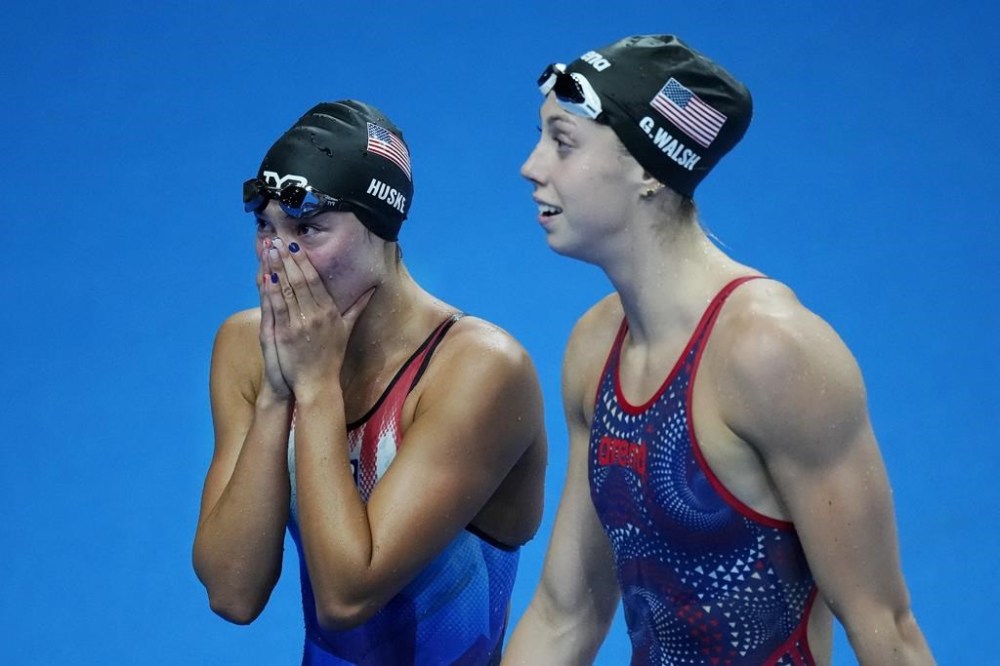 Torri Huske, left, of the United States, reacts after winning the women's 100-meter butterfly final with teammate Gretchen Walsh at the 2024 Summer Olympics, Sunday, July 28, 2024, in Nanterre, France. (AP Photo/Petr David Josek)