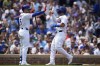 Chicago Cubs' Seiya Suzuki, right, high-fives designated hitter Christopher Morel as Suzuki scores on a single from Ian Happ during the first inning of a baseball game against the Milwaukee Brewers, Wednesday, July 24, 2024, in Chicago. (AP Photo/Erin Hooley)