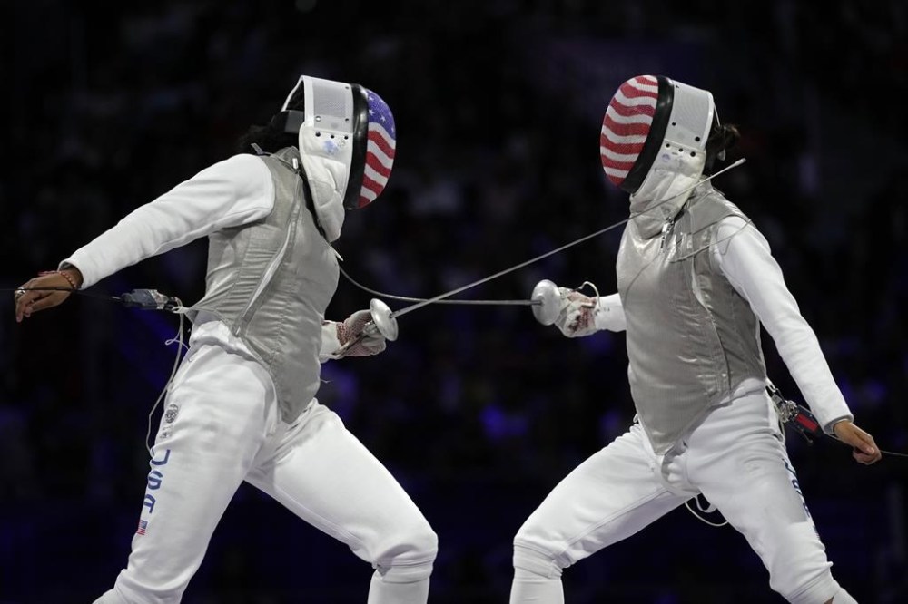 United States' Lee Kiefer, right, competes with United States' Lauren Scruggs in the women's individual Foil final match during the 2024 Summer Olympics at the Grand Palais, Sunday, July 28, 2024, in Paris, France. (AP Photo/Andrew Medichini)