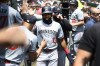 Minnesota Twins' Manuel Margot, center, is congratulated by teammates after scoring on a sacrifice fly by Brooks Lee against the Detroit Tigers during the second inning of a baseball game, Sunday, July 28, 2024, in Detroit. (AP Photo/Jose Juarez)
