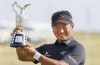 K.J. Choi poses with the Claret Jug after winning The Senior Open Presented by Rolex at Carnoustie Golf Links, in Carnoustie, Scotland, Sunday July 28, 2024. (Steve Welsh/PA via AP)