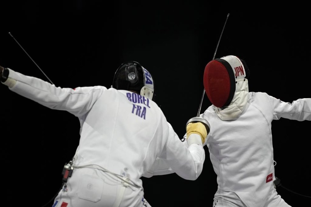 Japan's Koki Kano, right, competes with France's Yannik Borel in the men's individual Epee final match during the 2024 Summer Olympics at the Grand Palais, Sunday, July 28, 2024, in Paris, France. (AP Photo/Andrew Medichini)