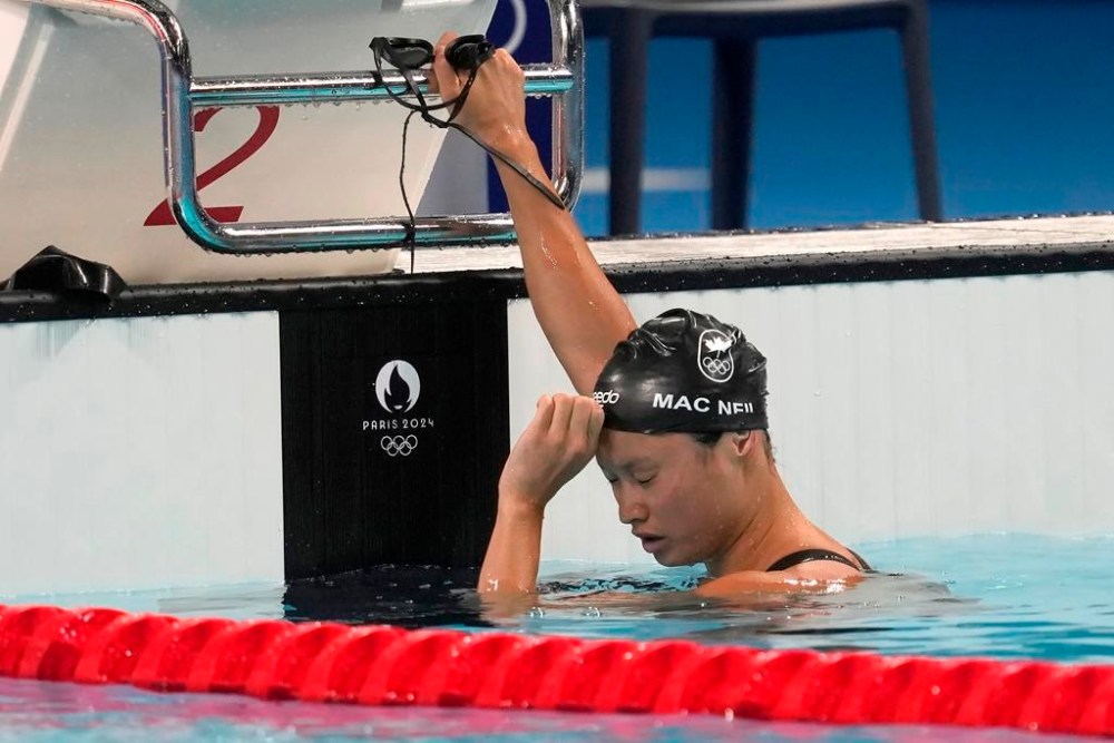 Margaret Mac Neil, of Canada, reacts after swimming in the women's 100m butterfly finals at the 2024 Summer Olympics, Sunday, July 28, 2024 in Nanterre, France. THE CANADIAN PRESS/Adrian Wyld