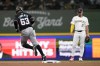 Miami Marlins' Xavier Edwards (63) rounds the bases in front of Milwaukee Brewers' Willy Adames, right, after hitting a solo home run during the first inning of a baseball game Sunday, July 28, 2024, in Milwaukee. (AP Photo/Aaron Gash)