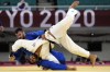 FILE - Victor Sterpu of Moldova, background and Tohar Butbul of Israel compete during their men's -73kg round of 16 judo match at the 2020 Summer Olympics in Tokyo, Japan, Monday, July 26, 2021. (AP Photo/Vincent Thian, FIle)