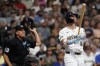 Milwaukee Brewers' Jake Bauers, right, watches his two-run home run during the first inning of a baseball game against the Miami Marlins, Sunday, July 28, 2024, in Milwaukee. (AP Photo/Aaron Gash)