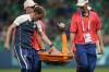 France's goalkeeper Pauline Peyraud-Magnin gives the thumb-up as she is carried off the pitch on a stretcher after getting injured during the women's Group A soccer match between Canada and France at Geoffroy-Guichard stadium during the 2024 Summer Olympics, Sunday, July 28, 2024, in Saint-Etienne, France. (AP Photo/Silvia Izquierdo)