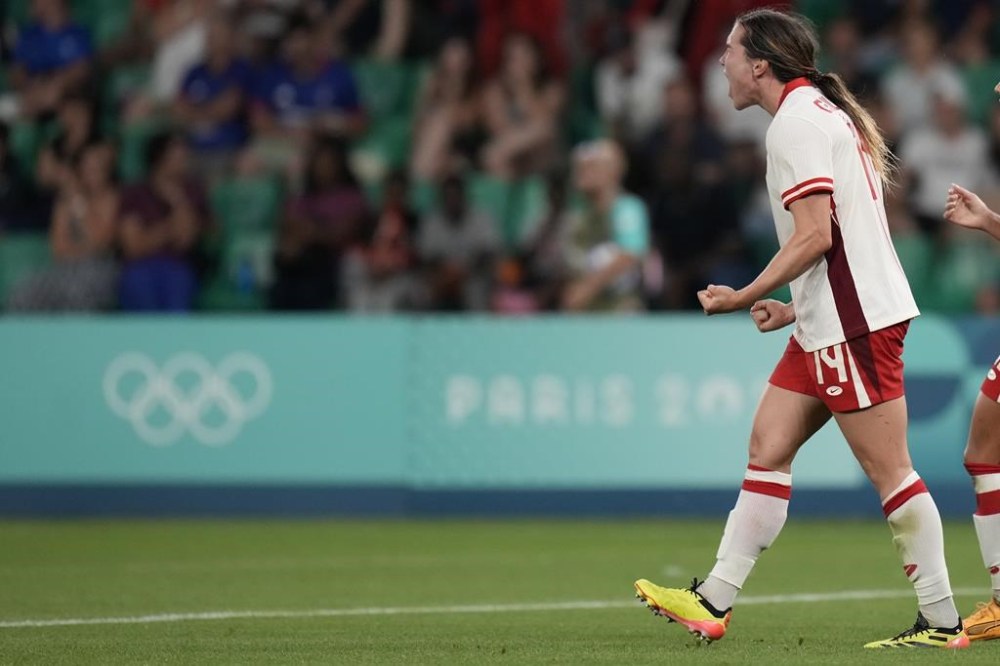 Canada's Vanessa Gille celebrates scoring her side's second goal during the women's Group A soccer match between Canada and France at Geoffroy-Guichard stadium during the 2024 Summer Olympics, Sunday, July 28, 2024, in Saint-Etienne, France. (AP Photo/Silvia Izquierdo)