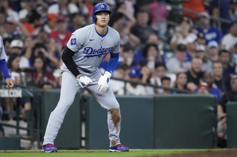 Los Angeles Dodgers designated hitter Shohei Ohtani leads off third base during the ninth inning of a baseball game against the Houston Astros, Sunday, July 28, 2024, in Houston. (AP Photo/Kevin M. Cox)