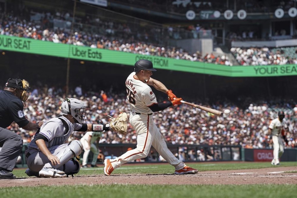 San Francisco Giants' Matt Chapman hits an RBI single against the Colorado Rockies in the sixth inning of a baseball game in San Francisco, Sunday, July 28, 2024. (AP Photo/Kavin Mistry)