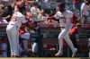 Los Angeles Angels' Taylor Ward (3) celebrates his grand slam with third base coach Eric Young Sr. during the fourth inning of a baseball game against the Oakland Athletics, Sunday, July 28, 2024, in Anaheim, Calif. (AP Photo/Ryan Sun)