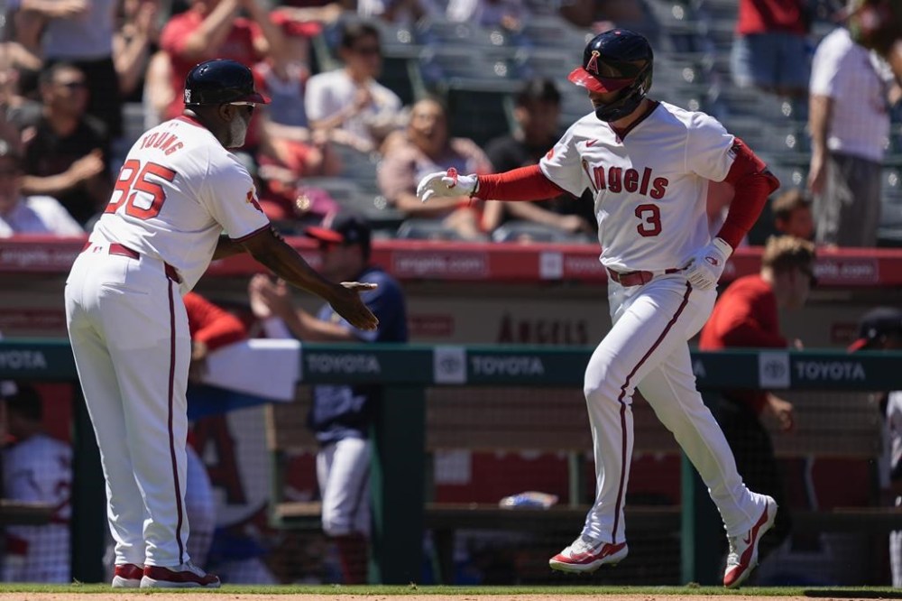 Los Angeles Angels' Taylor Ward (3) celebrates his grand slam with third base coach Eric Young Sr. during the fourth inning of a baseball game against the Oakland Athletics, Sunday, July 28, 2024, in Anaheim, Calif. (AP Photo/Ryan Sun)