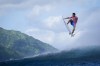 Kauli Vaast, of France, leaps over a wave during the second round of the 2024 Summer Olympics surfing competition Sunday, July 28, 2024, in Teahupo'o, Tahiti. (AP Photo/Gregory Bull)