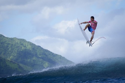 Kauli Vaast, of France, leaps over a wave during the second round of the 2024 Summer Olympics surfing competition Sunday, July 28, 2024, in Teahupo'o, Tahiti. (AP Photo/Gregory Bull)