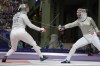Egypt's Nada Hafez and United States' Elizabeth Tartakovsky compete in the women's individual Sabre round of 32 competition during the 2024 Summer Olympics at the Grand Palais, Monday, July 29, 2024, in Paris, France. (AP Photo/Andrew Medichini)