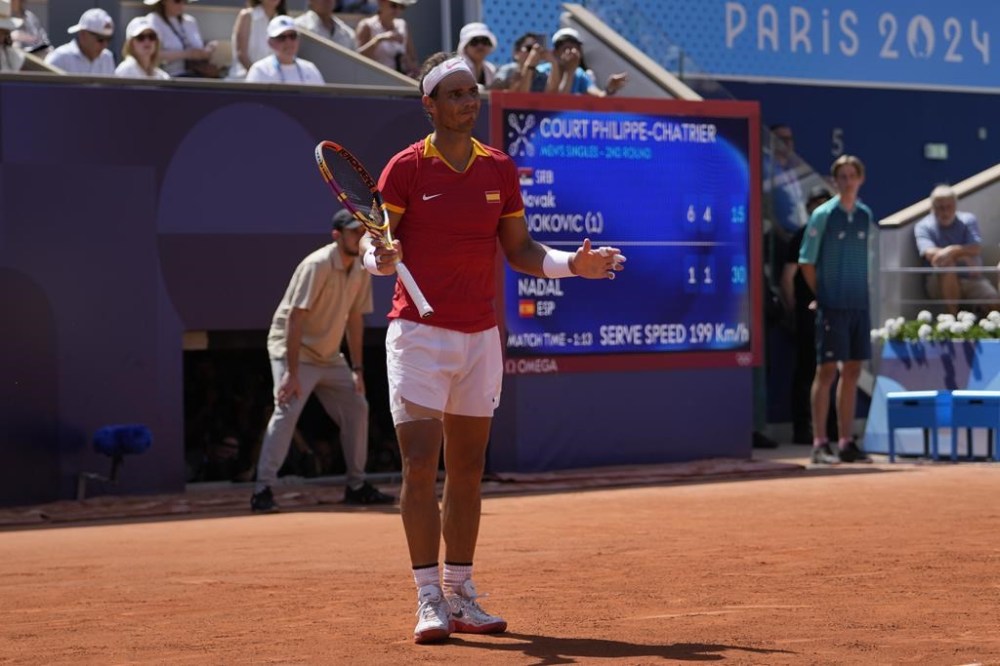 Spain's Rafael Nadal reacts as he plays Serbia's Novak Djokovic during their men's singles second round match at the 2024 Summer Olympics, Monday, July 29, 2024, at the Roland Garros stadium in Paris, France. (AP Photo/Andy Wong)
