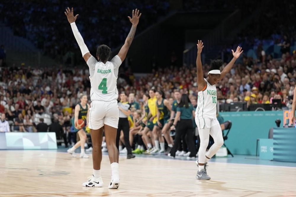 Elizabeth Balogun (4) and Promise Amukamara, of Nigeria, celebrate in a women's basketball game against Australia at the 2024 Summer Olympics, Monday, July 29, 2024, in Villeneuve-d'Ascq, France. (AP Photo/Mark J. Terrill)