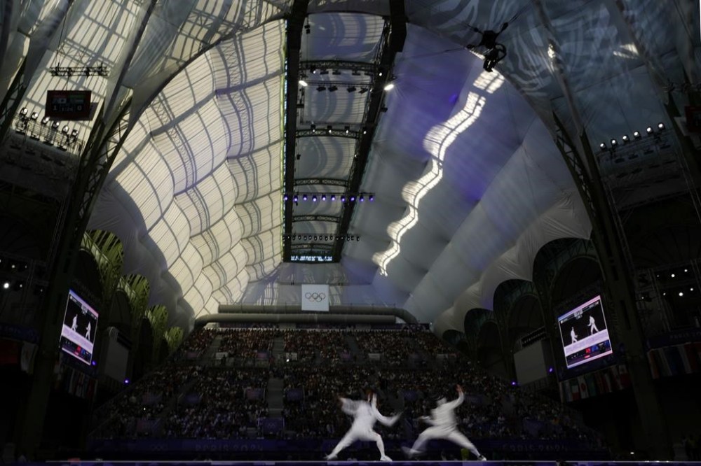 Japan's Koki Kano, left, competes with Hungary's Tibor Andrasfi in the men's individual Epee semifinal match during the 2024 Summer Olympics at the Grand Palais, Sunday, July 28, 2024, in Paris, France. (AP Photo/Andrew Medichini)