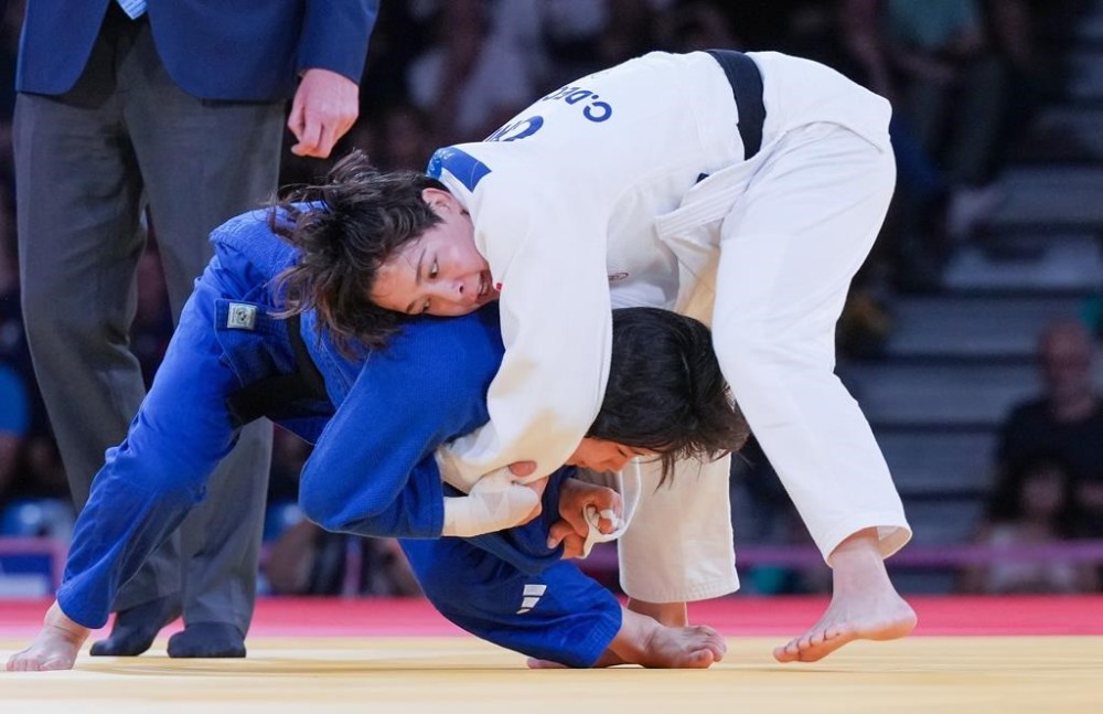 Canada's Christa Deguchi, top, competes against Mimi Huh of South Korea in women's under-57 kg judo gold medal match in Paris, France on Monday, July 29, 2024. THE CANADIAN PRESS/Christinne Muschi