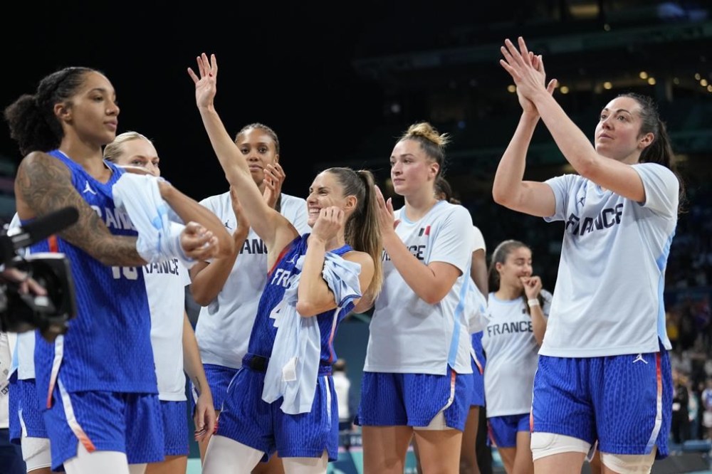 The French teams sauce their fans after defeating Canada in a women's basketball game at the 2024 Summer Olympics, Monday, July 29, 2024, in Villeneuve-d'Ascq, France. (AP Photo/Mark J. Terrill)