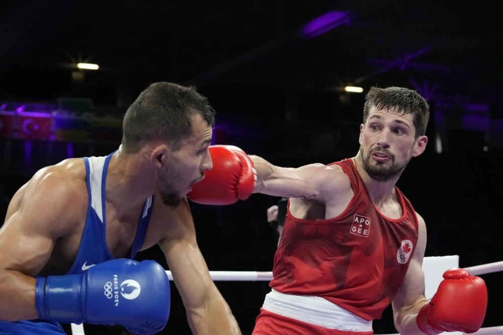 Canada's Wyatt Sanford hits Bulgaria's Radoslav Rosenov in their men's 63.5 kg preliminary boxing match at the 2024 Summer Olympics, Monday, July 29, 2024, in Paris, France. THE CANADIAN PRESS/AP-Ariana Cubillos
