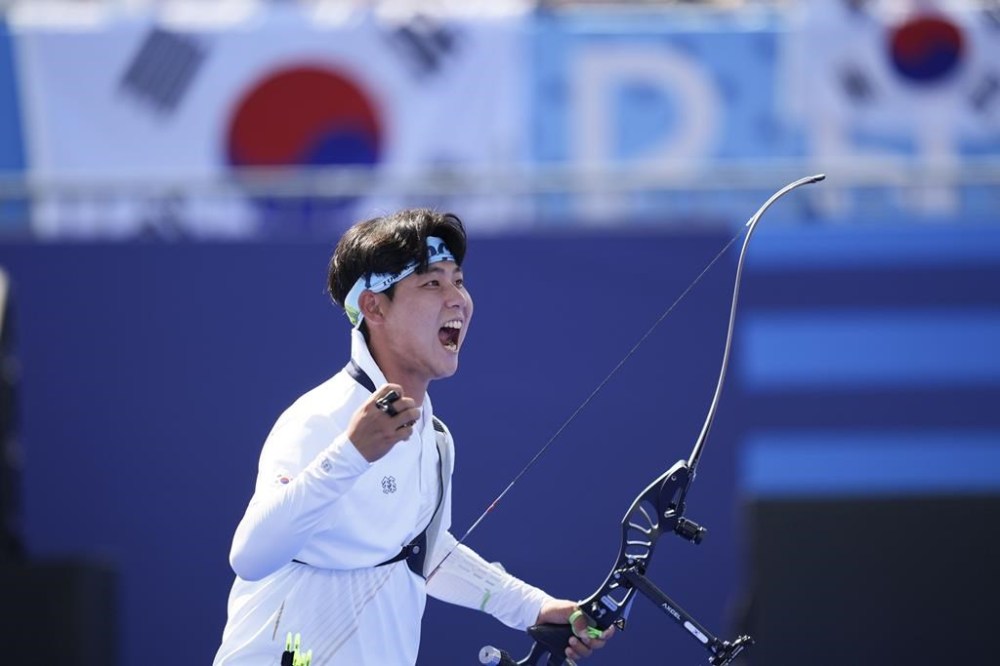 South Korea's Wooseok Lee celebrates winning during the men's team semifinals Archery competition against China at the 2024 Summer Olympics, Monday, July 29, 2024, in Paris, France. (AP Photo/Rebecca Blackwell)