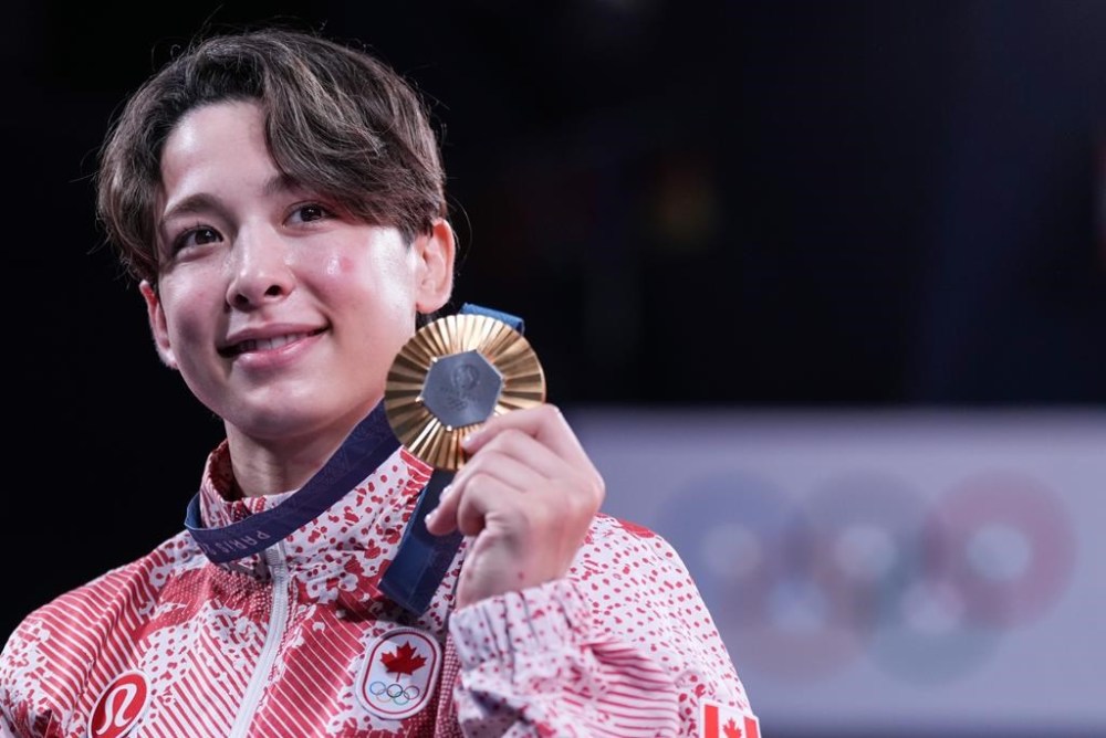 Canada's Christa Deguchi holds her gold medal after her win in the women's under-57 kg judo at the 2024 Summer Olympics in Paris, France on Monday, July 29, 2024. THE CANADIAN PRESS/Christinne Muschi