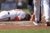 Baltimore Orioles' James McCann reacts after being hit by a pitch by Toronto Blue Jays starting pitcher Yariel Rodriguez during the first inning in the first baseball game of a doubleheader, Monday, July 29, 2024, in Baltimore. (AP Photo/Stephanie Scarbrough)