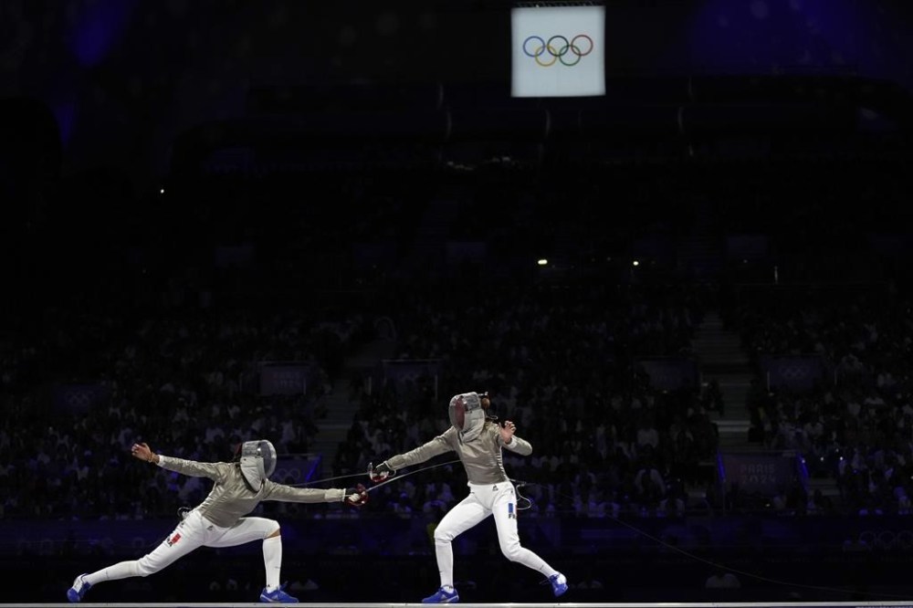France's Manon Apithy Brunet, right, competes with France's Sara Balzer in the women's individual Sabre final match during the 2024 Summer Olympics at the Grand Palais, Monday, July 29, 2024, in Paris, France. (AP Photo/Andrew Medichini)