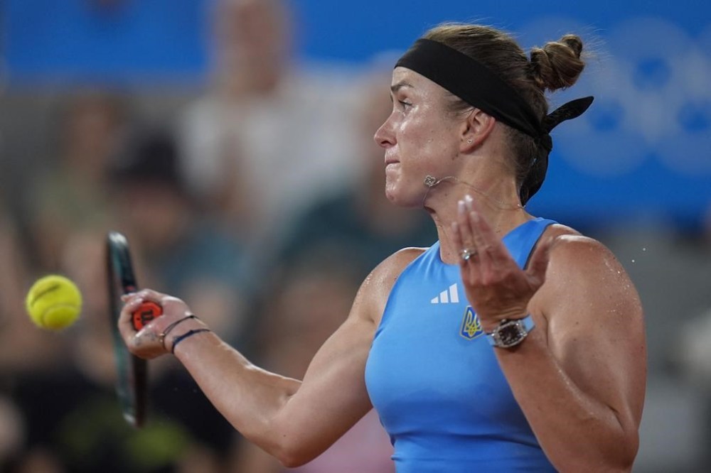 Elina Svitolina of Ukraine returns a forehand shot to Jessica Pegula of the United States during their women's singles second round match, at the 2024 Summer Olympics, Monday, July 29, 2024, at the Roland Garros stadium in Paris, France. (AP Photo/Andy Wong)