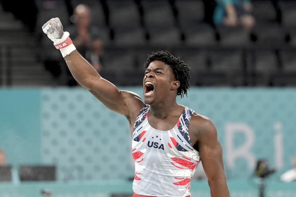 Fred Richard, of the United States, reacts after performing on the rings during the men's artistic gymnastics team finals round at Bercy Arena at the 2024 Summer Olympics, Monday, July 29, 2024, in Paris, France. (AP Photo/Abbie Parr)