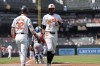 Baltimore Orioles' Colton Cowser (17) celebrates with Ryan O'Hearn (32) after scoring on an RBI hit by Ryan Mountcastle during the first inning in the first baseball game of a doubleheader against the Toronto Blue Jays, Monday, July 29, 2024, in Baltimore. (AP Photo/Stephanie Scarbrough)