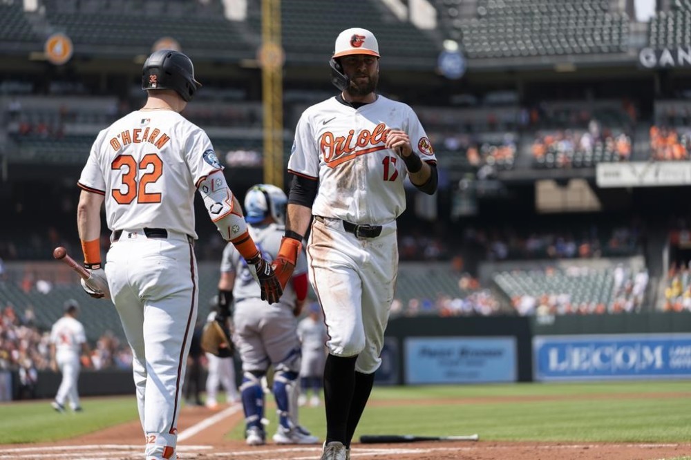 Baltimore Orioles' Colton Cowser (17) celebrates with Ryan O'Hearn (32) after scoring on an RBI hit by Ryan Mountcastle during the first inning in the first baseball game of a doubleheader against the Toronto Blue Jays, Monday, July 29, 2024, in Baltimore. (AP Photo/Stephanie Scarbrough)