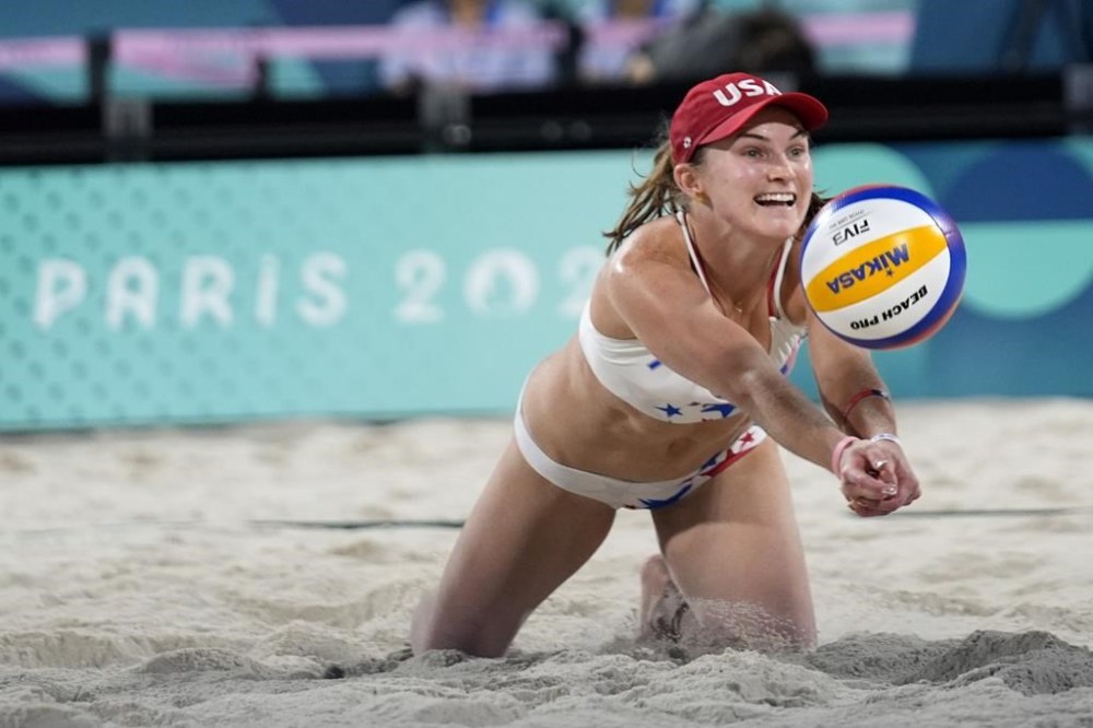 United States' Kristen Nuss dives for a shot in a victory over Australia in a beach volleyball match at the 2024 Summer Olympics, Monday, July 29, 2024, in Paris, France. (AP Photo/Robert F. Bukaty)
