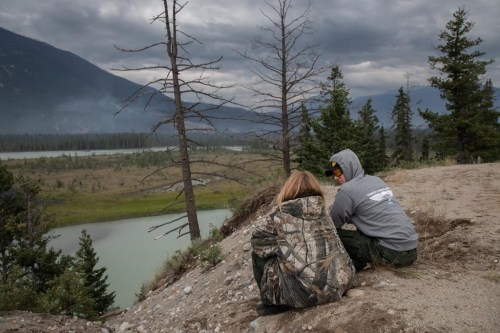 Parks Canada wants everyone to know that despite the wildfire scorching Jasper National Park, Bear 222 is OK. Firefighters on a break watch helicopters bucket smouldering wildfires in the forest outside of Jasper, Alta., on Friday, July 26, 2024. THE CANADIAN PRESS/Amber Bracken