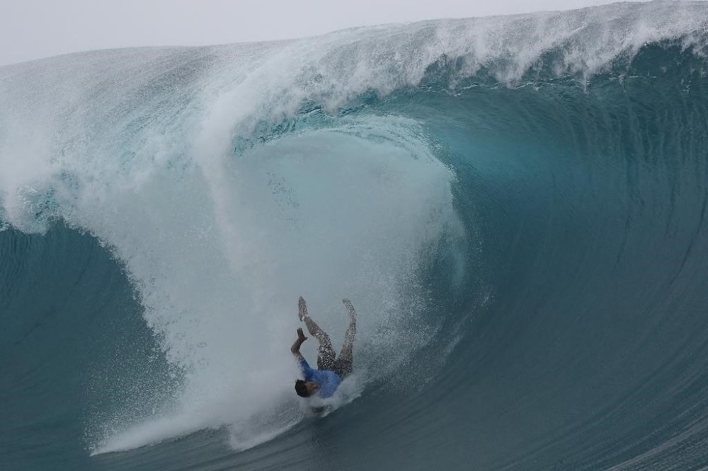 Connor O'Leary, of Japan, falls from a wave during the third round of the 2024 Summer Olympics surfing competition Monday, July 29, 2024, in Teahupo'o, Tahiti. (AP Photo/Gregory Bull)